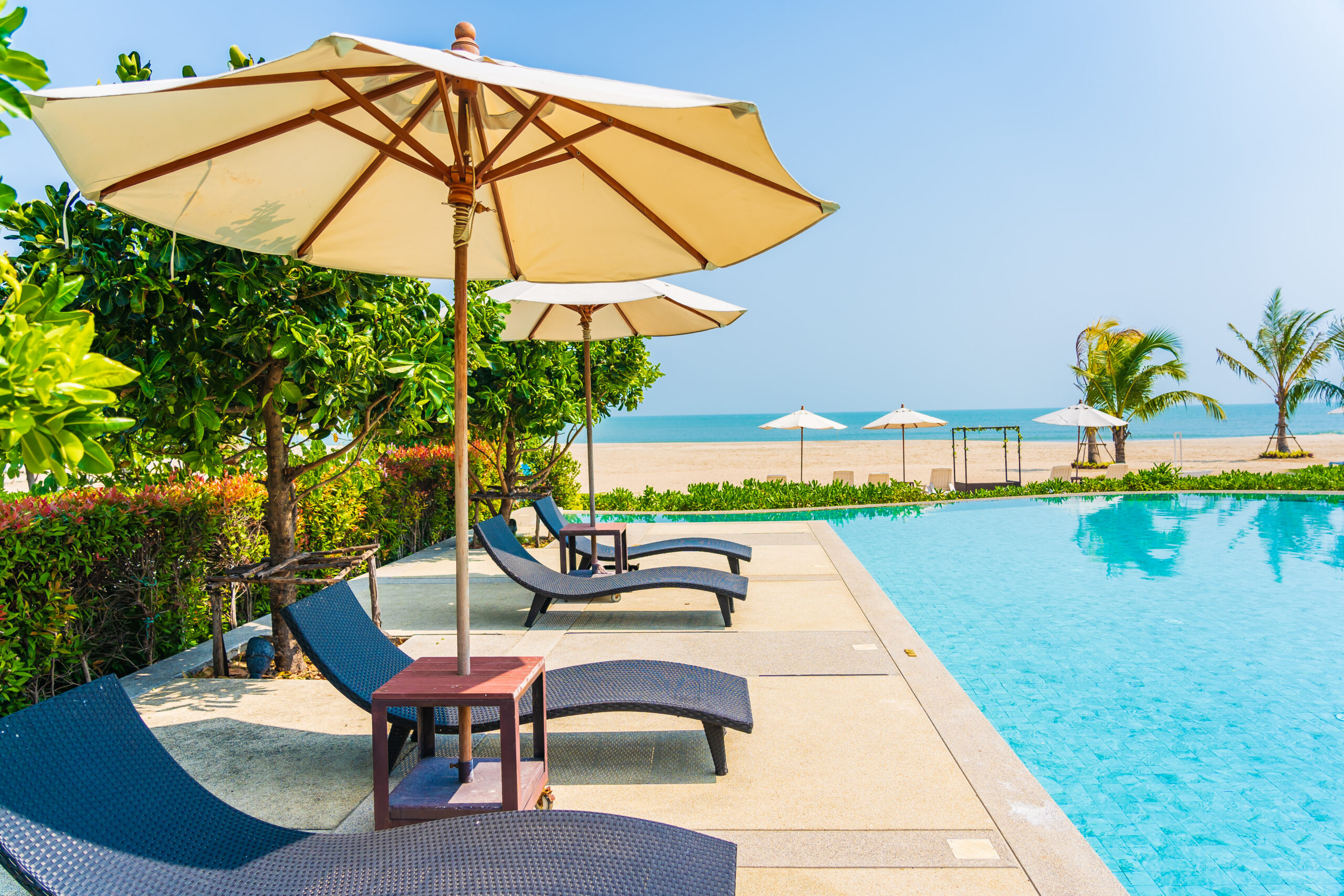 umbrella and chair around outdoor swimming pool in hotel resort