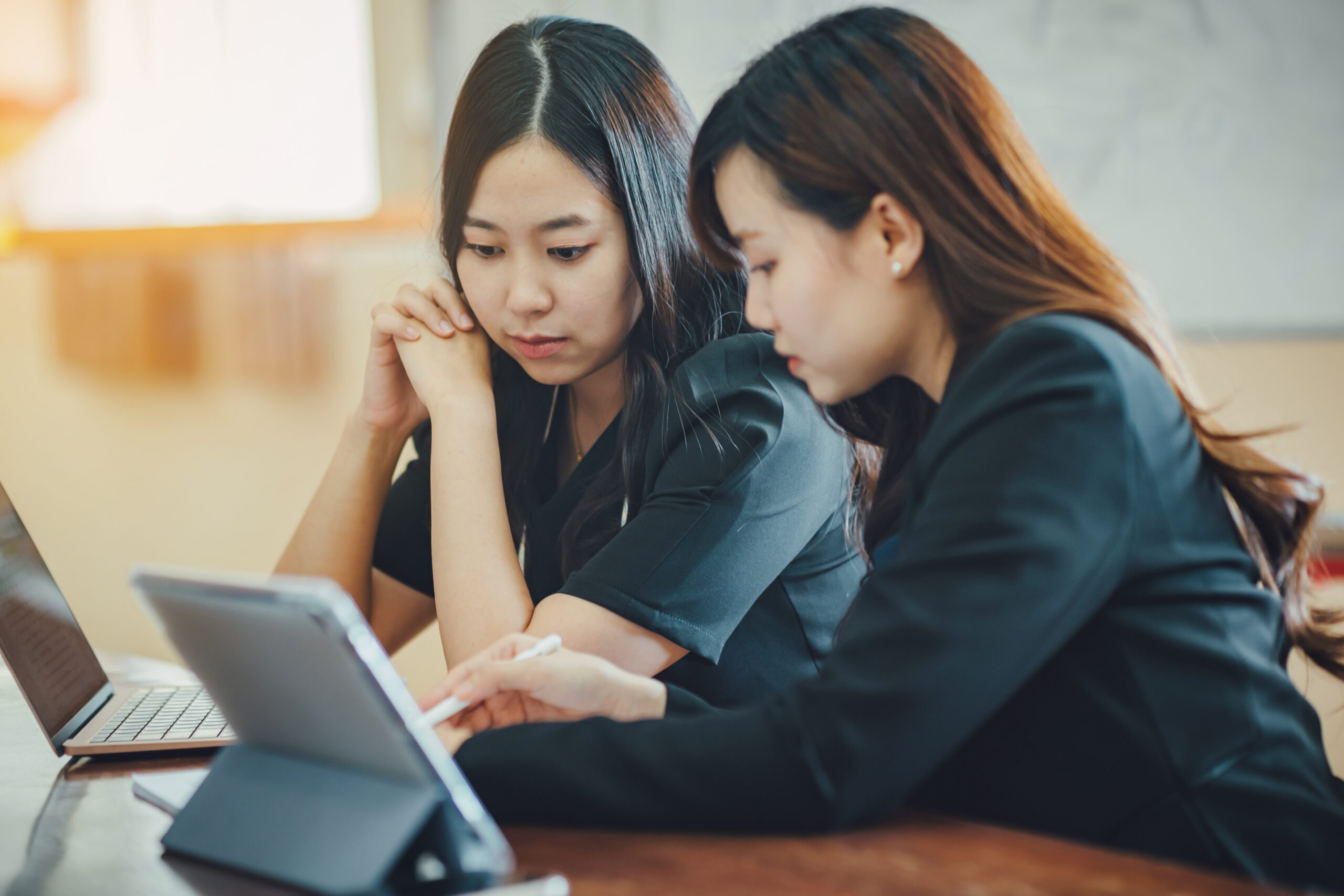 young professionals team of businesswoman talking on a meeting in modern creative office analyzing company financial report. concept for business market, tax and economy project consult.